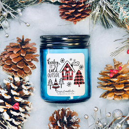Baby It's Cold Outside Candle - label surrounded by pine cones and Christmas decorations